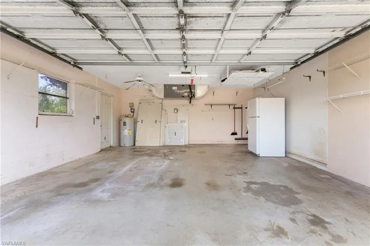 Laundry area with sink, cabinets, washer and clothes dryer, and light tile patterned floors