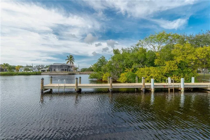 View of pool featuring glass enclosure, a yard, and a patio area