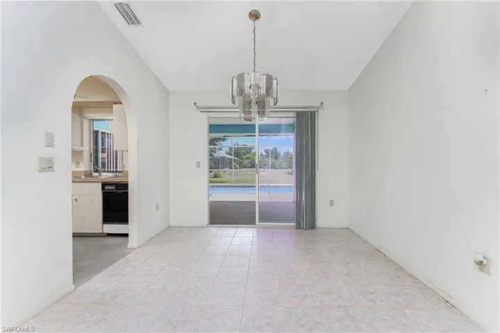 Unfurnished room featuring lofted ceiling, ceiling fan, and dark hardwood / wood-style floors