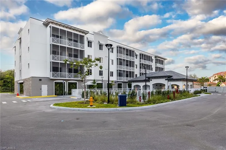 View of building exterior with central AC unit and fence