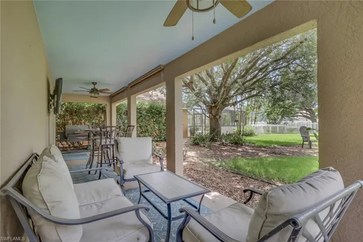 Covered outdoor patio with textured wall finish and ceiling fans
