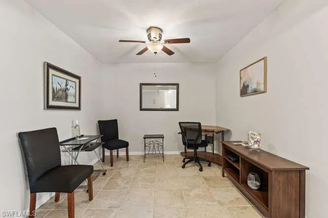 Office with light tile patterned floors and ceiling fan