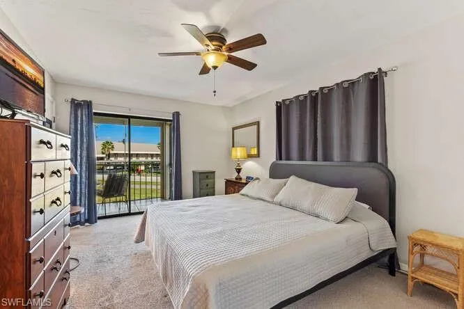 Bedroom with light carpet, access to exterior, and ceiling fan
