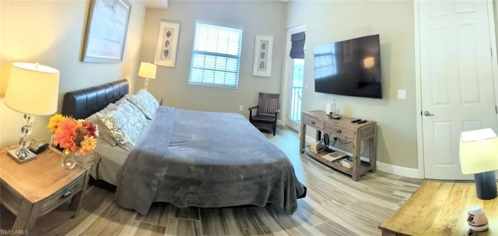 Bedroom with light wood-type flooring and baseboards