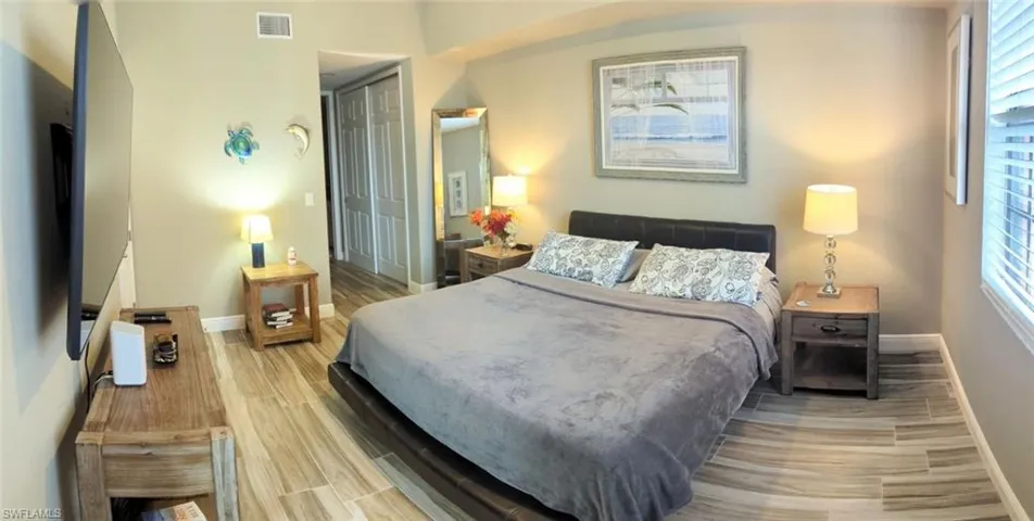 Bedroom with wood finish floors and a closet
