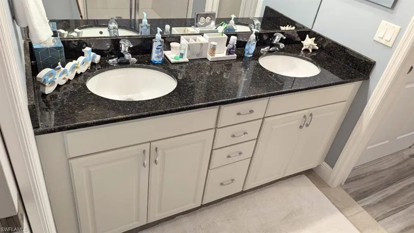 Full bath featuring double vanity