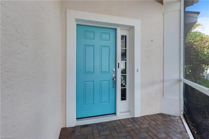 Doorway to property featuring stucco siding