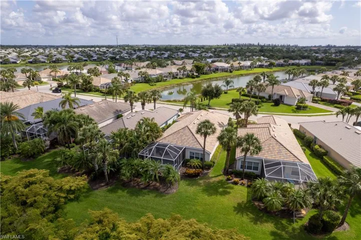 Aerial perspective of suburban area featuring a large body of water