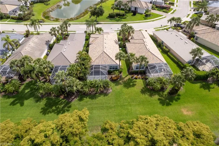 Aerial perspective of suburban area featuring a nearby body of water