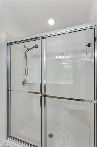 Full bathroom featuring a shower stall