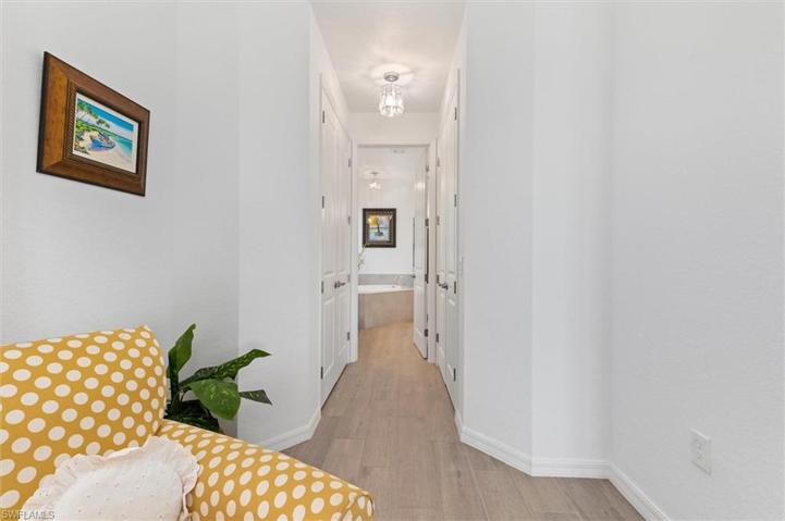 Hallway to Master Bathroom featuring walk in closets