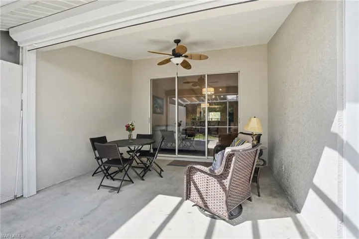 View of patio featuring a ceiling fan and outdoor dining area