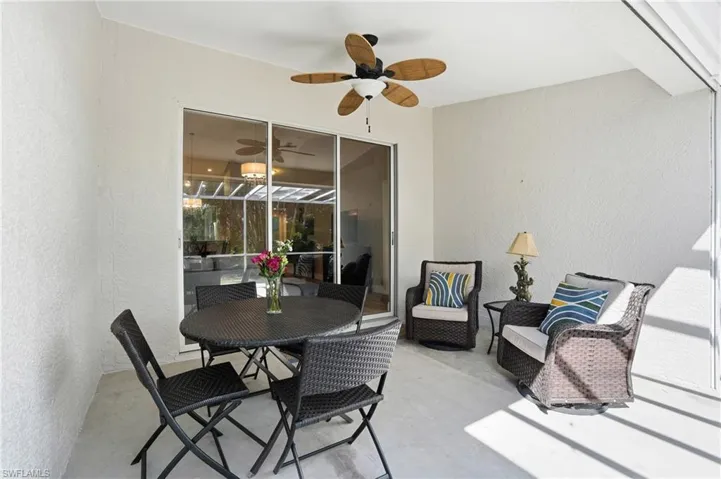 View of patio with a ceiling fan and outdoor dining space