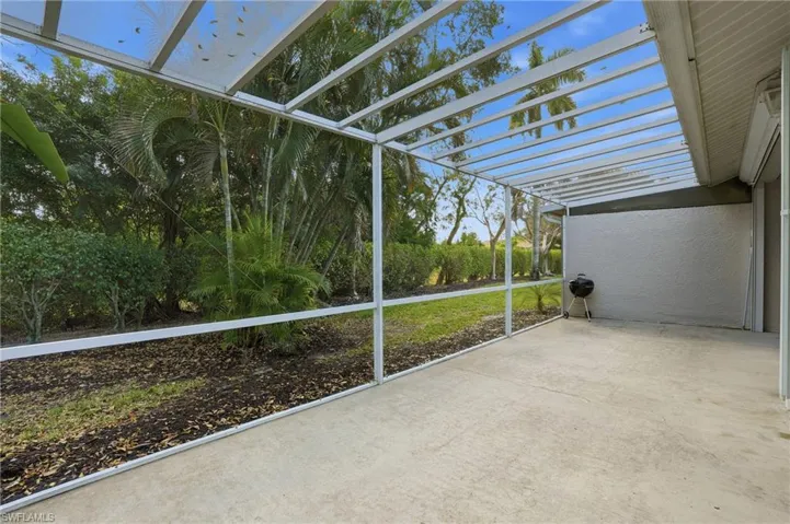 Unfurnished sunroom featuring a pergola and a patio area