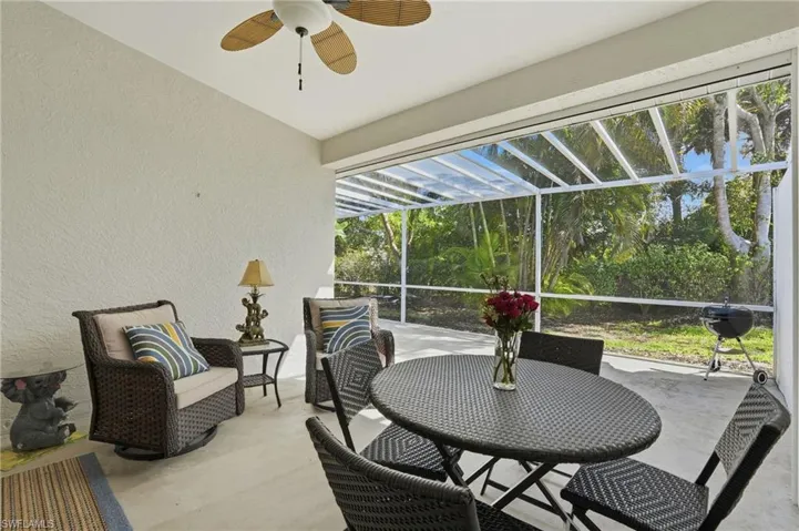 Sunroom with a patio, a ceiling fan, and outdoor dining area