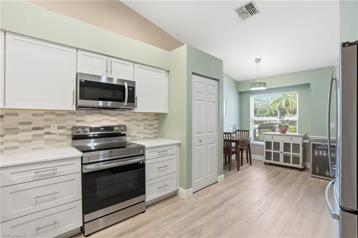The recently updated Kitchen features new backsplash, cabinets, countertops, and appliances