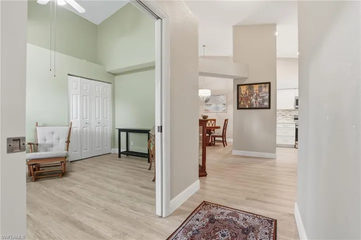 Hall featuring a high ceiling and light wood finished floors