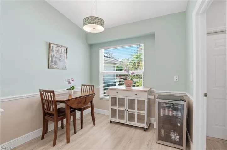 Dining area featuring wine cooler and light wood-type flooring