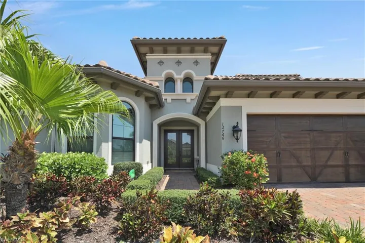 Doorway to property with french doors and a garage