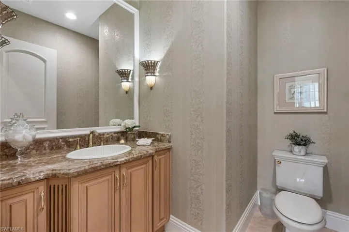 There is guest powder room has Emperador Dark marble top on the vanity, and is right off the kitchen and dining room.