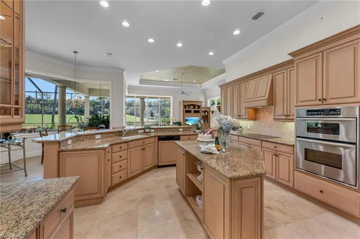 Abundant cabinetry for plenty of storage, with a bar just around the corner.