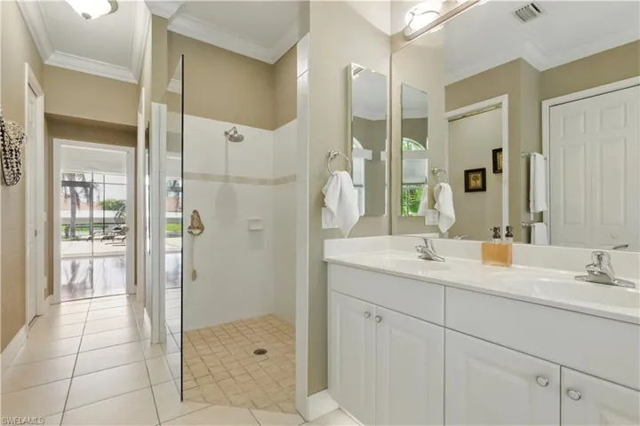 Master Bathroom Walk in Shower with double vanity, light tile patterned floors