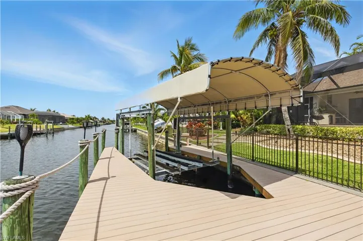 Dock area featuring boat lift and a water view
