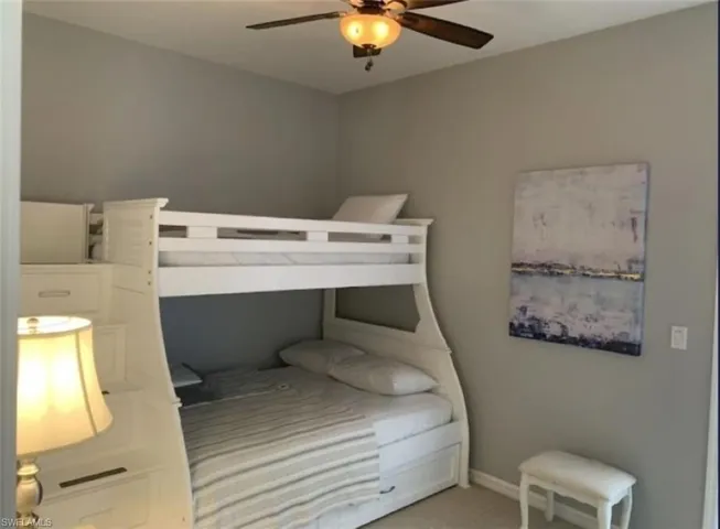 Bedroom featuring ceiling fan and carpet