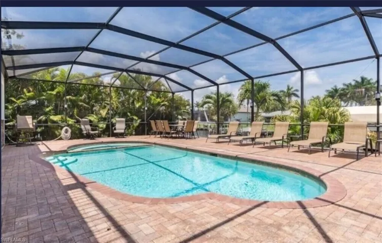 View of swimming pool featuring a patio and a lanai
