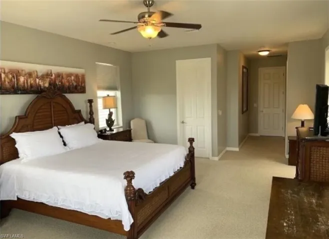 Bedroom featuring ceiling fan and light carpet