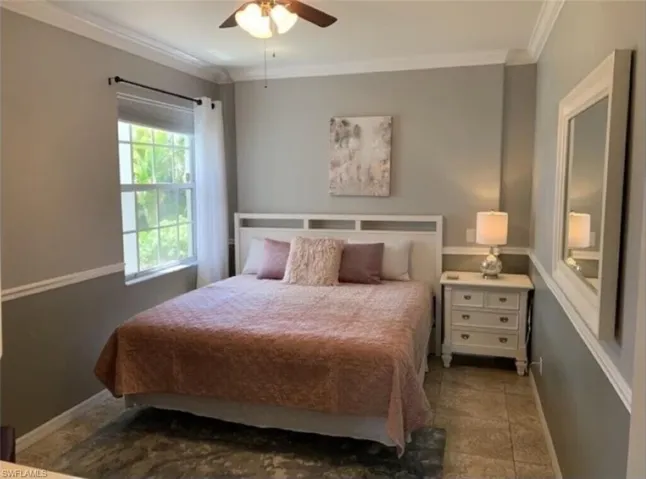 Bedroom featuring crown molding, ceiling fan, and tile patterned floors