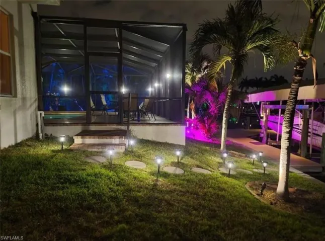 Yard at night featuring a patio