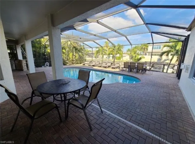 View of swimming pool featuring a lanai and a patio area
