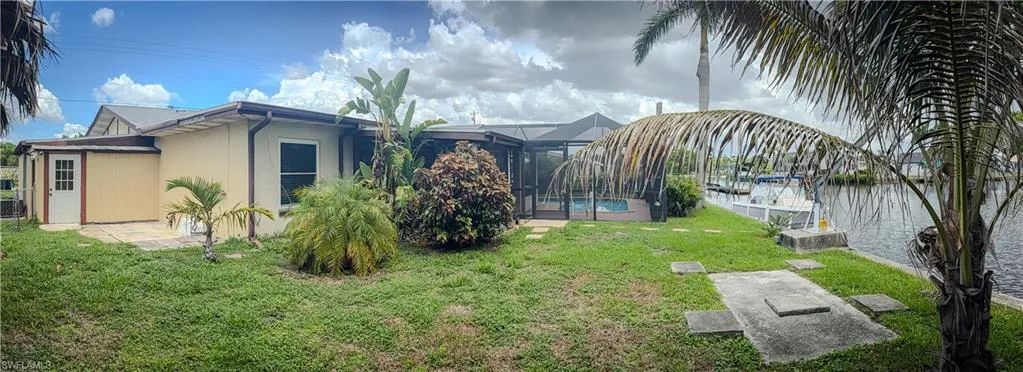 View of green lawn featuring glass enclosure