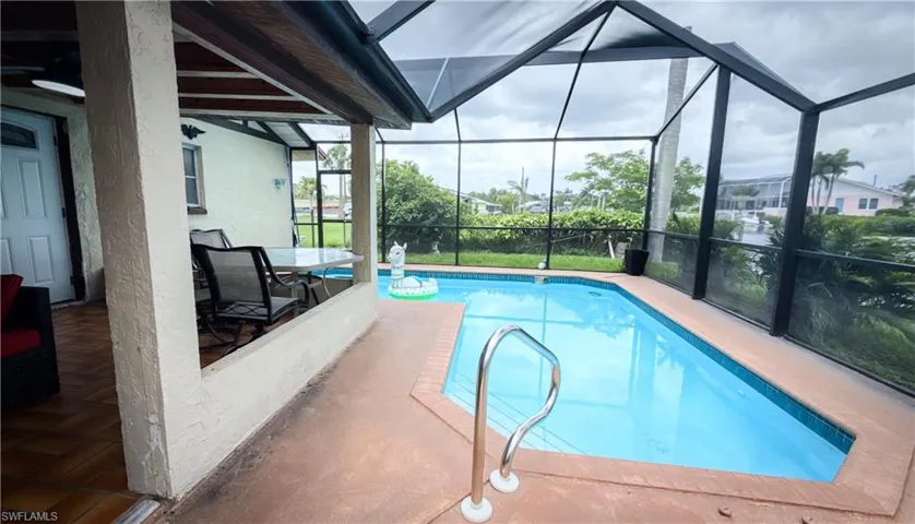 Outdoor pool with glass enclosure and a patio