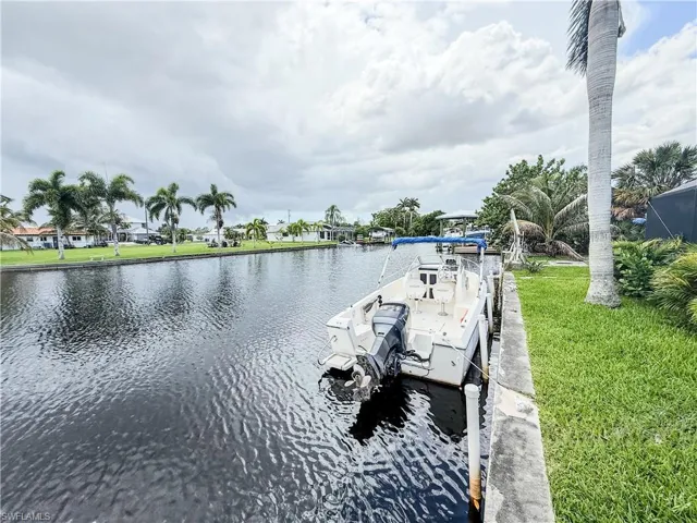 Dock with a water view and a yard