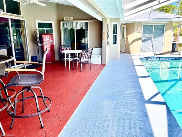 View of pool with a patio and ceiling fan