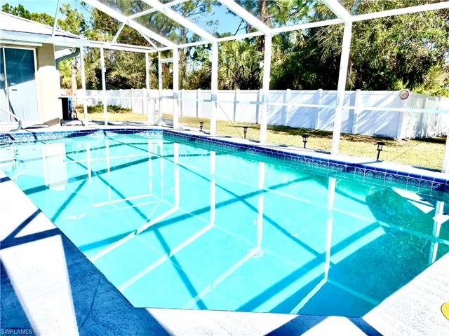 View of swimming pool with a lanai