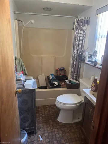 Full bathroom featuring vanity and shower / bath combination with curtain