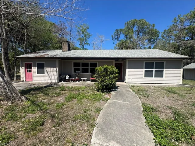 Single story home featuring a chimney
