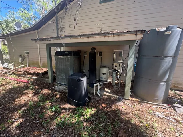 Exterior view of a central air condition unit and a water softener
