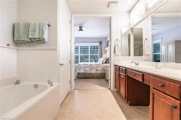 Primary bathroom with tub and vanity
