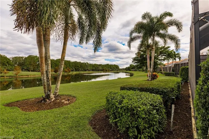View of yard with water and golf views