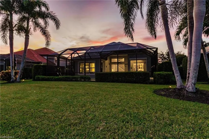 Rear view of property at dusk