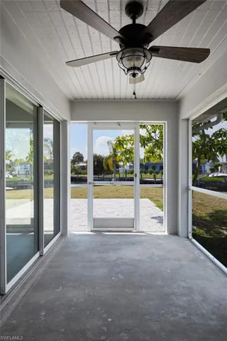 Out door screened-in lanai with ceiling fan and sink