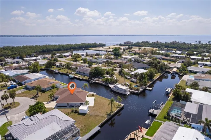 Birds eye view of property with a water view and a residential view