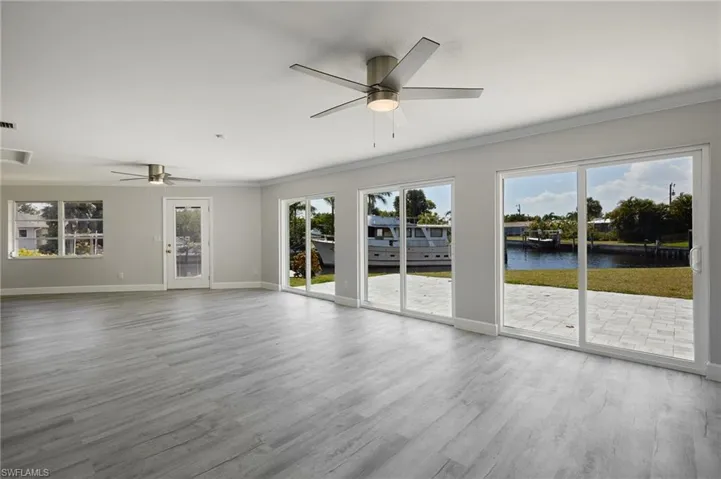 Unfurnished living room featuring a water view