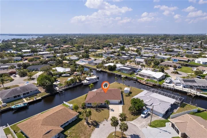 Birds eye view of property with a water view and a residential view