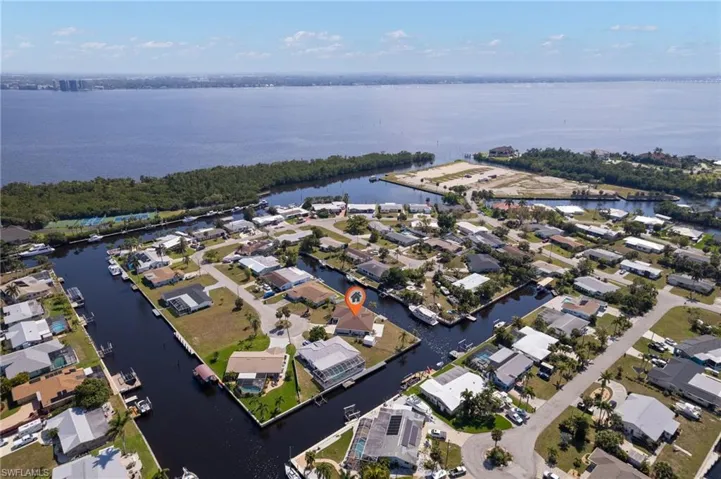 Birds eye view of property with a water view and a residential view