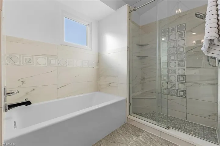 Primary tub and shower with beautiful tile